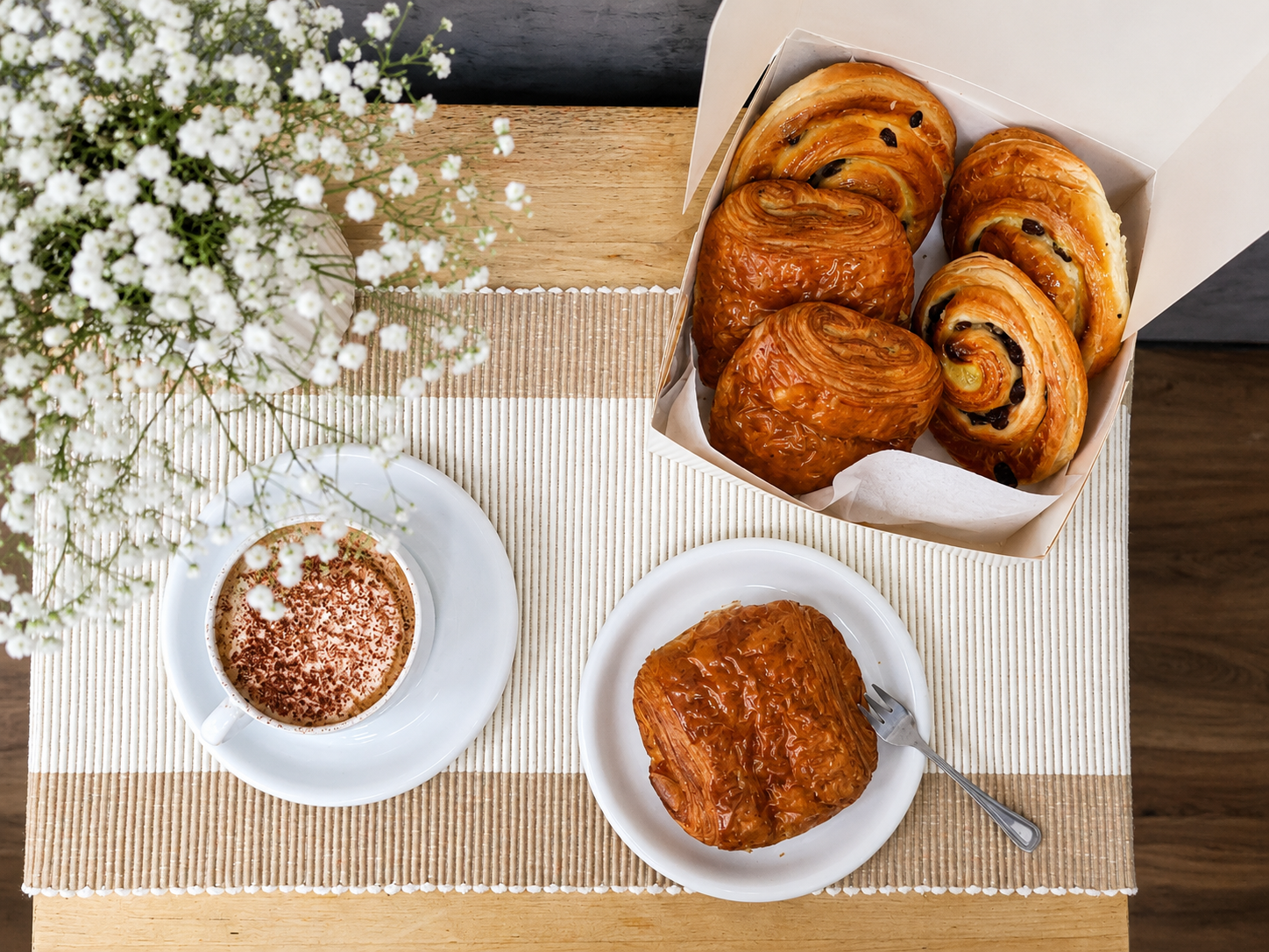 A box containing 5 cinnamon buns.